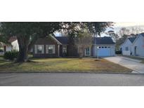 Charming brick home with an attached garage, mature trees, and a well-maintained lawn at 404 Snowy Egret Dr., Murrells Inlet, SC 29576