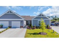 Charming single-story home with gray siding, well-manicured lawn and an attached one car garage at 4053 Taranto Loop # C, Myrtle Beach, SC 29579
