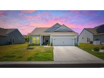 Charming single-story home with a well-manicured lawn, inviting curb appeal, and attached two-car garage at 4449 Honir Dr., Myrtle Beach, SC 29579