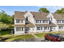 Inviting townhouse with gray siding, multiple windows, and well-maintained landscaping at 500 Fairway Village Dr. # 3-L, Myrtle Beach, SC 29588