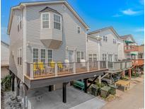 Coastal home featuring a large deck with outdoor seating, carport, and durable siding at 6001-1168 S Kings Hwy., Myrtle Beach, SC 29575