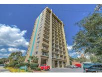 View of the Tower on the Green building featuring multi-story condos, parking and landscaping on a sunny day at 7500 N Ocean Blvd. # 6061, Myrtle Beach, SC 29572