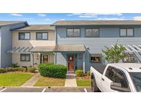 Charming townhouse with blue siding, landscaped front yard, and parking spot in front at 775 Plantation Dr. # 28, Little River, SC 29566