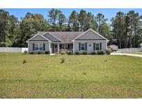 Charming single-story home featuring a well-manicured lawn and quaint landscaping at 95 Timber Run Dr., Georgetown, SC 29440