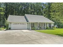 Charming single-story home with a well-manicured lawn and attached two-car garage at 125 Gavin Hill Ct., Aynor, SC 29511
