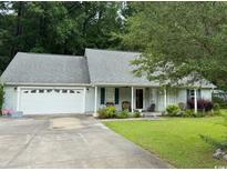 Charming single-story home with a well-manicured lawn, attached garage, and inviting front porch at 125 Gavin Hill Ct., Aynor, SC 29511