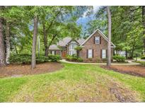 Charming brick home with lush landscaping and mature trees in a desirable neighborhood at 15 Cherbourg Ct., Pawleys Island, SC 29585