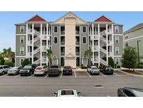 Attractive condo building with exterior staircases and ample parking in a coastal community at 186 Ella Kinley Circle # 101, Myrtle Beach, SC 29588