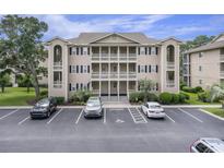 Three-story condo building with parking and covered balconies at 1900 Duffy St. # H-8, North Myrtle Beach, SC 29582
