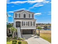 Charming three-story home with black shutters, stylish staircase and ground floor garage at 208 W Palms Dr., Myrtle Beach, SC 29579