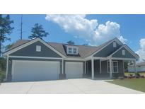Charming single-story home with a two-car garage, inviting front porch, and tasteful modern exterior at 225 Rivers Edge Dr., Myrtle Beach, SC 29588