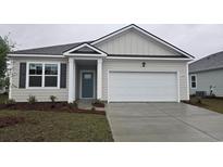 Charming single-story home featuring a two-car garage, blue door, and professionally landscaped front yard at 2863 Riverboat Way, Conway, SC 29526