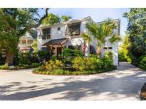 Charming white two-story home with lush landscaping and a welcoming front entrance at 309 Sunset Trail, Myrtle Beach, SC 29577