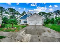 Charming two-story home with a two-car garage, well-manicured lawn and landscaping at 3091 Viceroy Loop, Little River, SC 29566