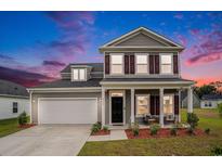Charming two-story home with gray siding, shutters, a well-manicured lawn, and a welcoming front porch at 3129 Palma Way, Myrtle Beach, SC 29579