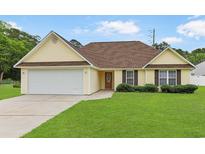 Charming single-story home with a well-maintained lawn and attached garage at 316 Watercress Dr., Longs, SC 29568
