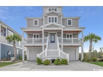 Beautiful two-story home featuring elevated construction, double garages, and charming covered front porch at 445 Harbour View Dr., Myrtle Beach, SC 29579