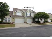 Charming two-story home with double garage and manicured lawn at 6172 Catalina Dr. # 612, North Myrtle Beach, SC 29582