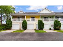Charming multi-colored townhomes featuring garages, white railings, and well-manicured landscaping at 6500 Colonial Dr. # 2, Myrtle Beach, SC 29572