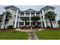 Beautiful three story condo with lush landscaping, tall white columns, and outdoor balconies at 665 Tupelo Ln. # 17-D, Longs, SC 29568