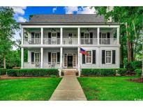 Charming two-story home features a large front porch with white columns and black shutters at 9 Winnowing Way, Pawleys Island, SC 29585