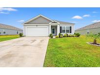 Charming one-story home with a well-manicured lawn, attached garage, and inviting front entrance at 1031 Corn Husk Loop, Conway, SC 29527