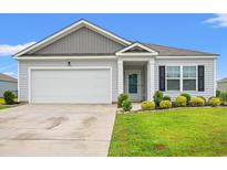 Charming single-story home with manicured lawn, attached garage, and neutral siding at 1031 Corn Husk Loop, Conway, SC 29527