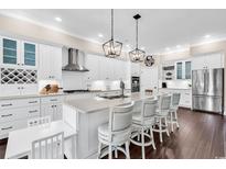 Bright, airy kitchen with white cabinetry, stainless steel appliances, and a spacious center island with seating at 1210 East Isle Of Palms Ave., Myrtle Beach, SC 29579