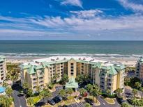 Stunning aerial view of an oceanfront condo complex featuring manicured grounds and a pristine beach at 135 S Dunes Dr. # 501, Pawleys Island, SC 29585