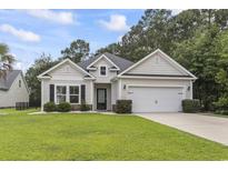 Charming single Gathering home featuring a manicured lawn, attached two car garage, and gray siding at 1600 Palmetto Palm Dr., Myrtle Beach, SC 29579