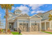 Charming exterior with a two car garage, stone accents, and a well manicured yard with mature landscaping at 201 West Isle Of Palms Ave., Myrtle Beach, SC 29579