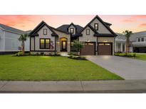 Charming two-story home featuring a landscaped yard, a two-car garage, and stone veneer accents at 2205 Yellow Morel Way, Myrtle Beach, SC 29579
