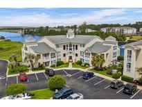 A beautiful condominium complex with manicured landscaping, ample parking, and waterfront views under a sunny sky at 222 Landing Rd. # 1811, North Myrtle Beach, SC 29582