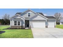 Charming two-story home with a well-manicured lawn and a three car garage at 227 Sundrop Way, Conway, SC 29526