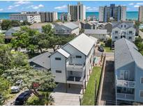 Stunning aerial view of the modern home, showcasing the backyard pool and proximity to the ocean at 4617 Hedrick St., North Myrtle Beach, SC 29582