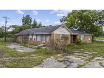 Ranch-style brick home with overgrown landscaping and neglected surroundings at 4860 Highway 378, Conway, SC 29527