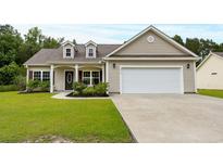 Charming one-story home with well-maintained lawn, neutral siding, and a two car attached garage at 5115 Huston Rd., Conway, SC 29526
