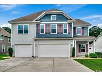 Charming two-story home with a three-car garage, gray siding, and red shutters at 5153 Country Pine Dr., Myrtle Beach, SC 29579