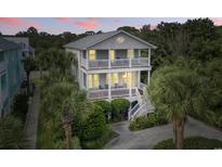 Charming two-story home with double balconies and lush tropical landscaping offers inviting curb appeal at 5407 N Ocean Blvd., Myrtle Beach, SC 29577