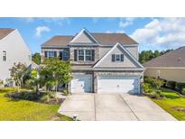 Charming two-story home with a brick and siding exterior and a spacious three-car garage at 5621 Camilla Ct., Myrtle Beach, SC 29579