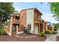 Charming townhouse featuring a private balcony, fenced patio, and well-maintained landscaping at 614 15Th Ave. S # 41, Surfside Beach, SC 29575