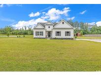 Charming one-story home with black shutters and a spacious front yard at 7377 Pauley Swamp Rd., Conway, SC 29527