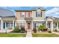Charming townhome with manicured landscaping and inviting red front door at 837 Triple Ct. # 837, Myrtle Beach, SC 29588