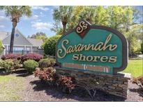 Savannah Shores Condominium Community sign surrounded by greenery and palm trees on a bright, sunny day at 9779 Leyland Dr. # 3, Myrtle Beach, SC 29572