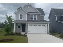 Charming two-story home featuring gray siding, a two-car garage, and a well-manicured front lawn at 1260 Saxon Ct., Myrtle Beach, SC 29579
