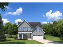 Charming two-story home features a two-car garage, light gray siding, and a well-manicured lawn at 1517 Hope Pointe Dr, North Myrtle Beach, SC 29582