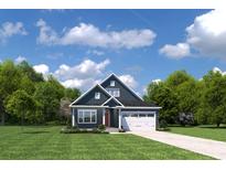 Charming two-story home featuring a red door, white garage, and well-manicured lawn at 1605 Hope Pointe Dr, North Myrtle Beach, SC 29582