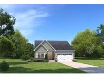 Charming single-Gathering home featuring a one-car garage, manicured lawn, and neutral color palette at 1617 Hope Pointe Dr, North Myrtle Beach, SC 29582