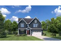 Charming two-story home featuring a well-manicured lawn and attached two car garage at 1657 Hope Pointe Dr, North Myrtle Beach, SC 29582