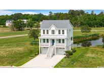 Charming two-story home with a gray roof, a white facade, a balcony, and an inviting staircase at 1716 Cravens St., Georgetown, SC 29440